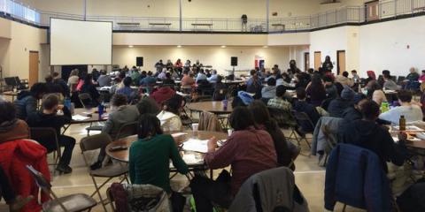People listening to a presenter at the North American Solidarity Economy Forum.